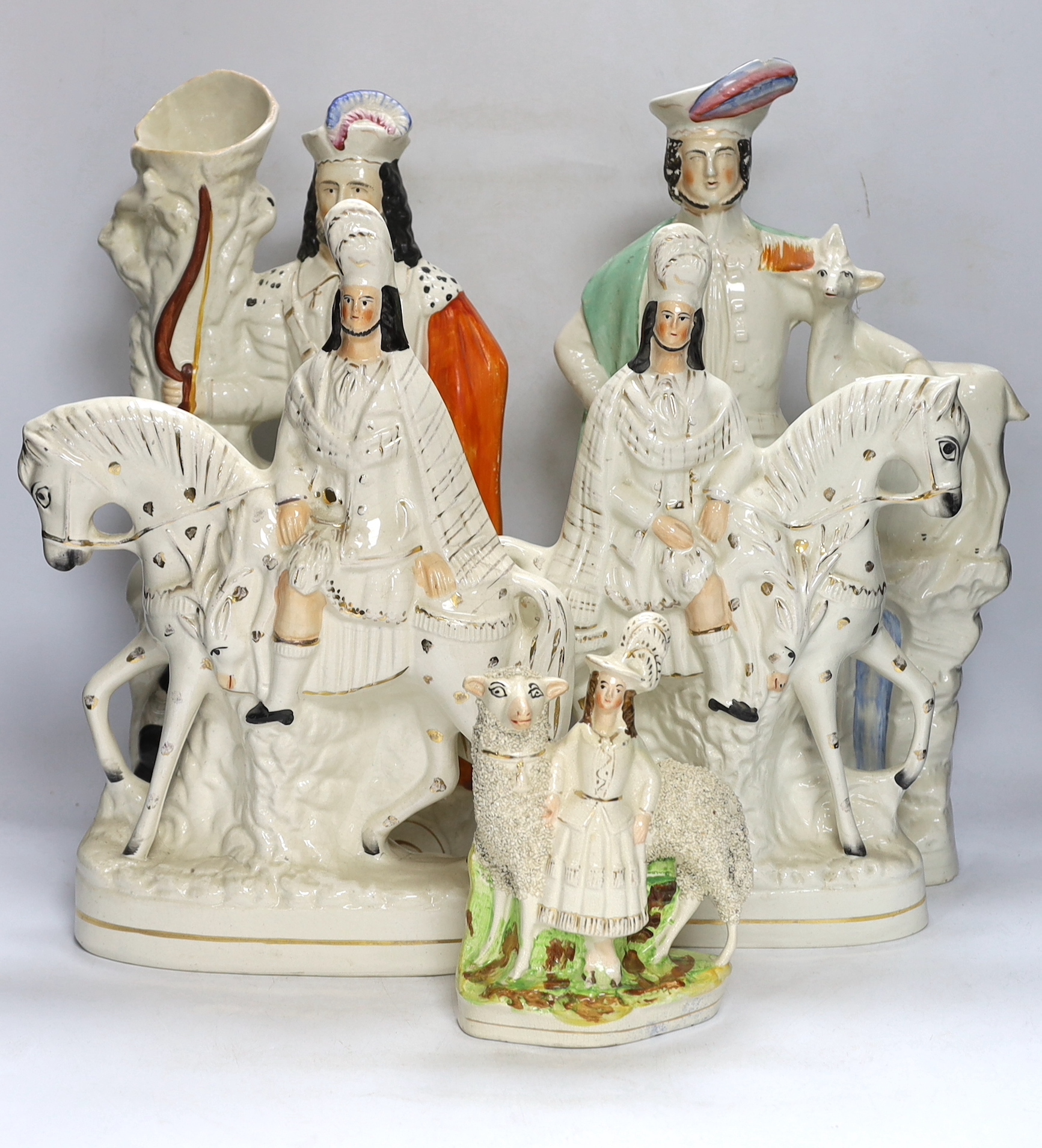 A pair of large mid 19th century Staffordshire pottery highland hunters, on horseback and three other Staffordshire pottery groups, largest 44 cm high (5)